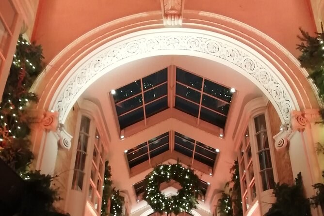 The entrance of a covered shopping arcade dressed with wreaths and garlands