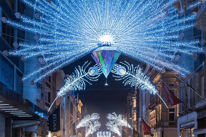 A great blue peacock tail of lights spread over a street of designer shops
