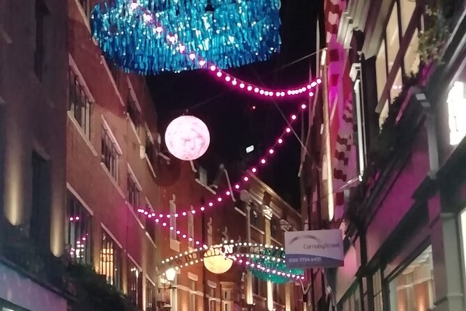 Pink strings of lights and glowing globes hung over a narrow lane